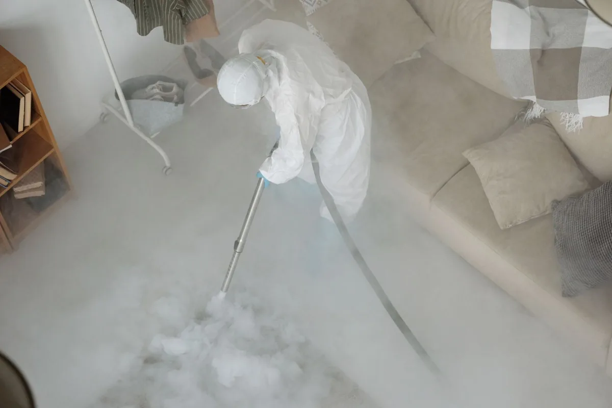 Biohazard cleanup technician in protective equipment, Lockwood, MT